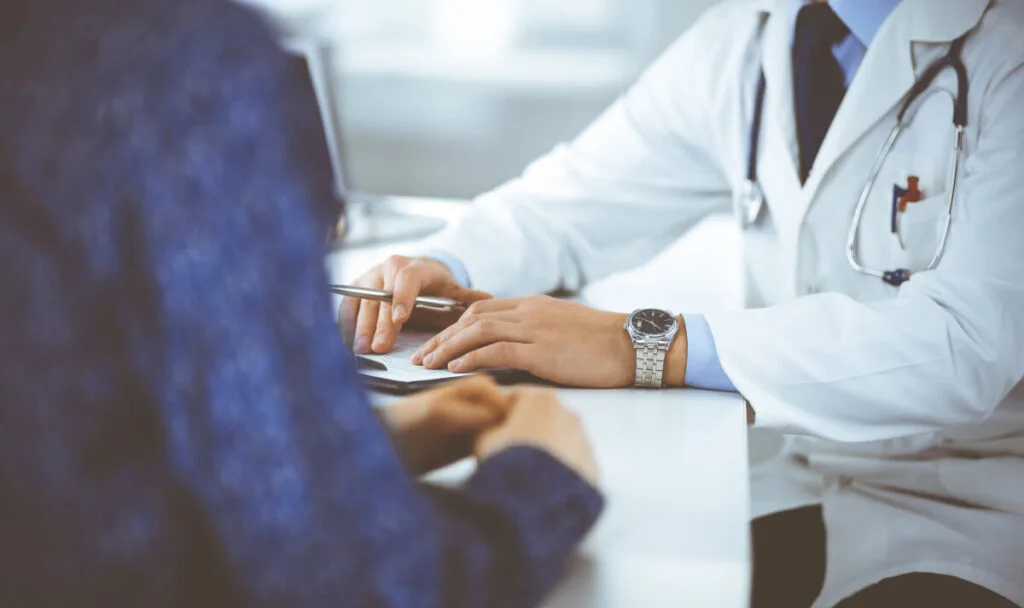 vein doctor carefully listening to patient about varicose and spider vein problems